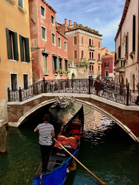 Gondola going under a bridge in Venice