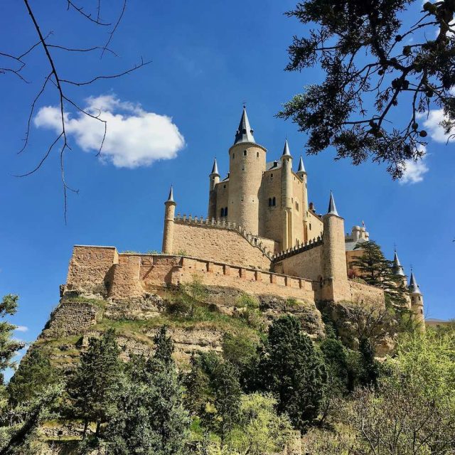 The Segovia Alcazar seen from the park down below