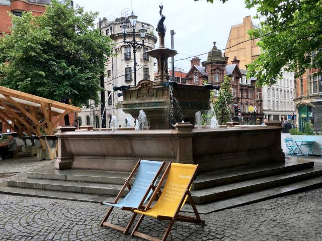 Square in Manchester with fountains and deckchairs